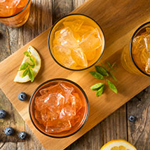 colorful fruit juice in glasses with ice